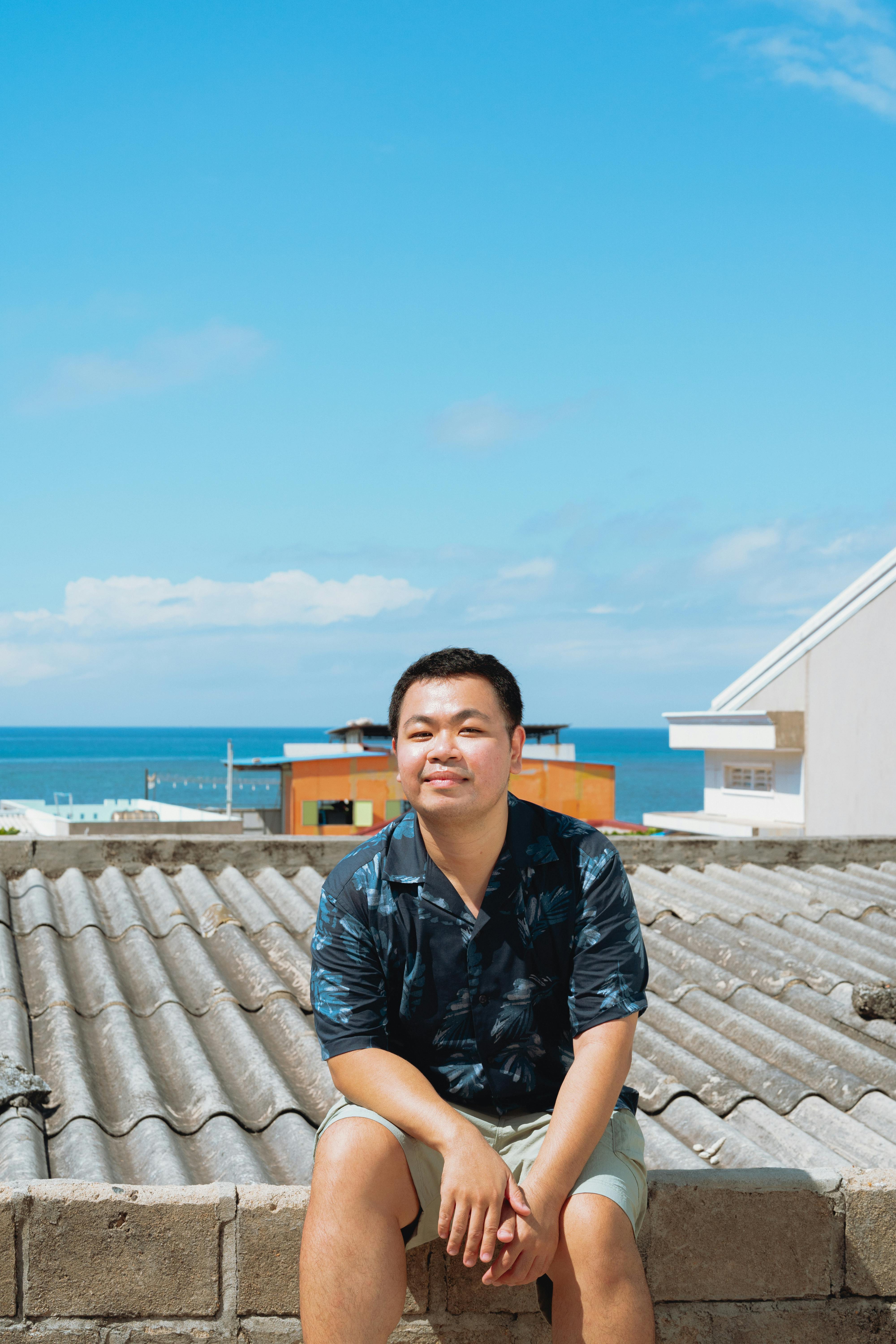 Casual portrait of a man on a rooftop with ocean view in Bình Thuận, Vietnam.