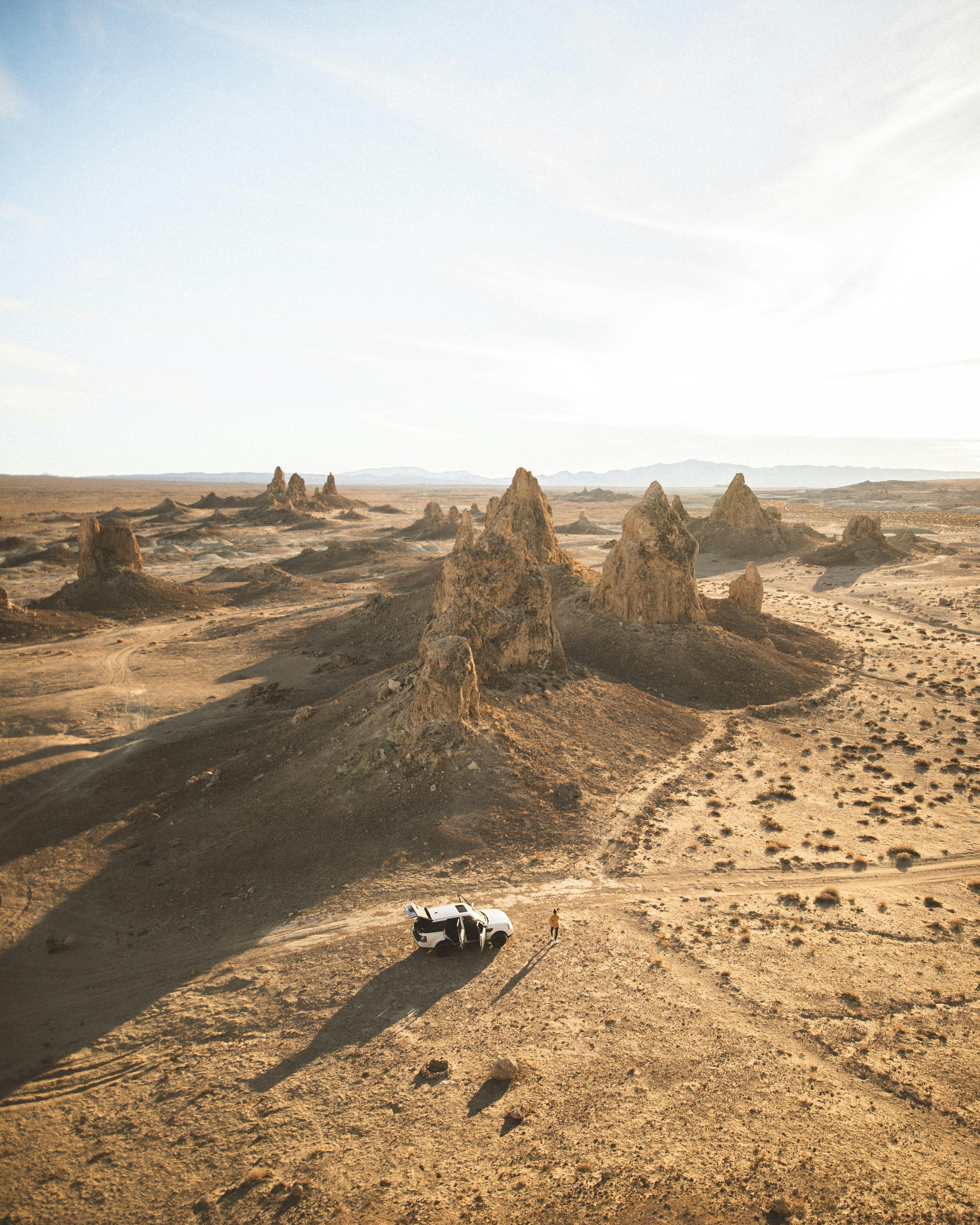 aerial photo of vehicle near rock formations