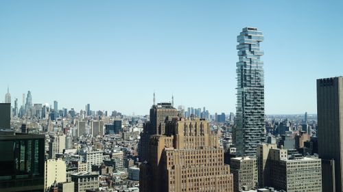 Free Captivating view of New York City skyline featuring iconic skyscrapers and clear blue sky. Stock Photo