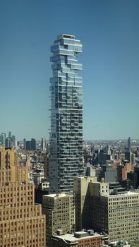 Stunning view of a unique skyscraper in New York City with a clear blue sky.