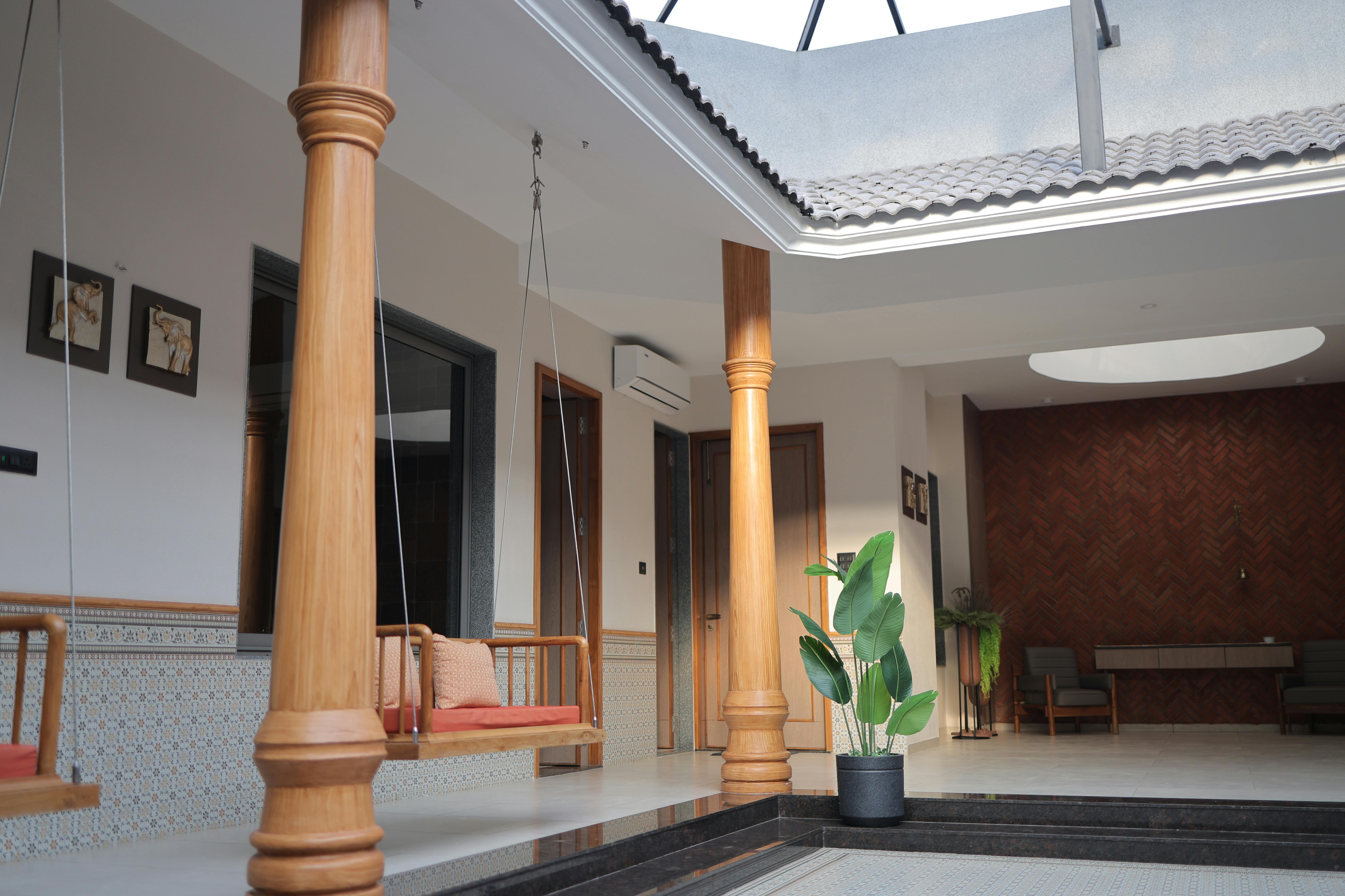 what is residential assisted living - Beautiful indoor courtyard featuring a wooden swing, skylight, and modern decor.
