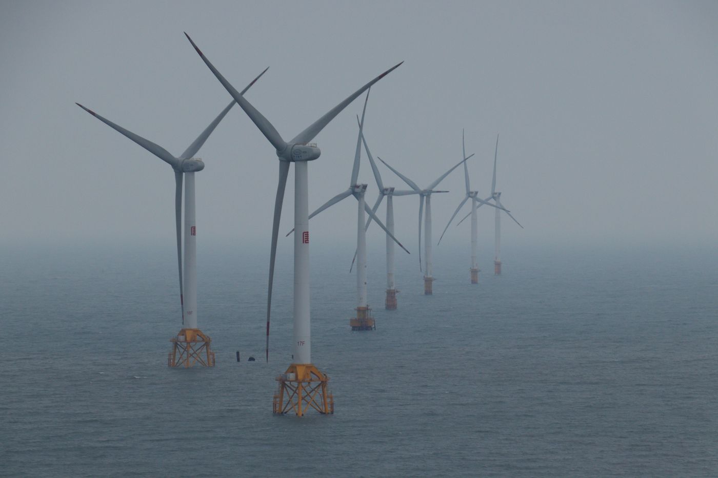 Offshore wind turbines generating clean energy in the ocean breeze.