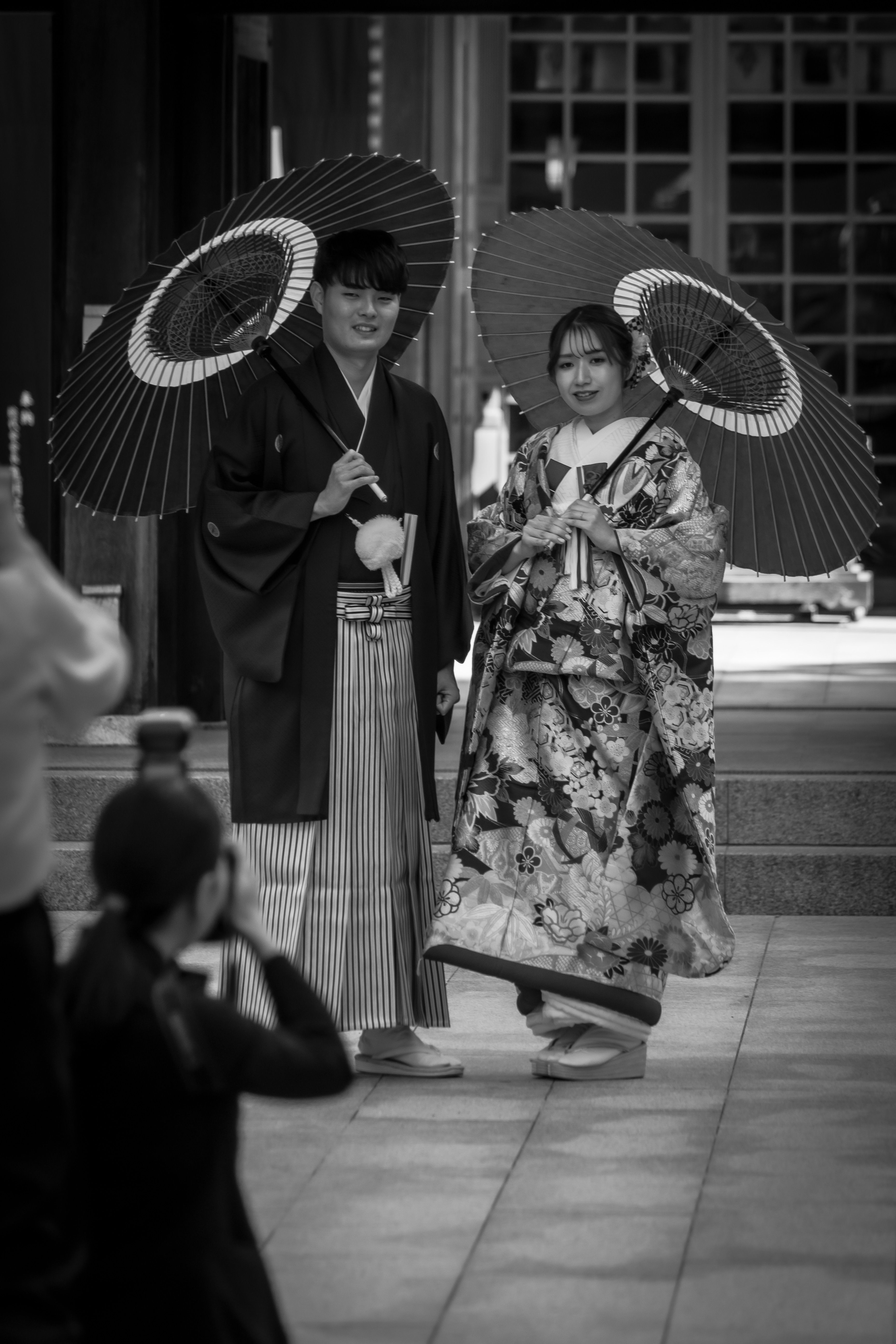 A person using a Japanese marriage dating app on a smartphone in Tokyo.