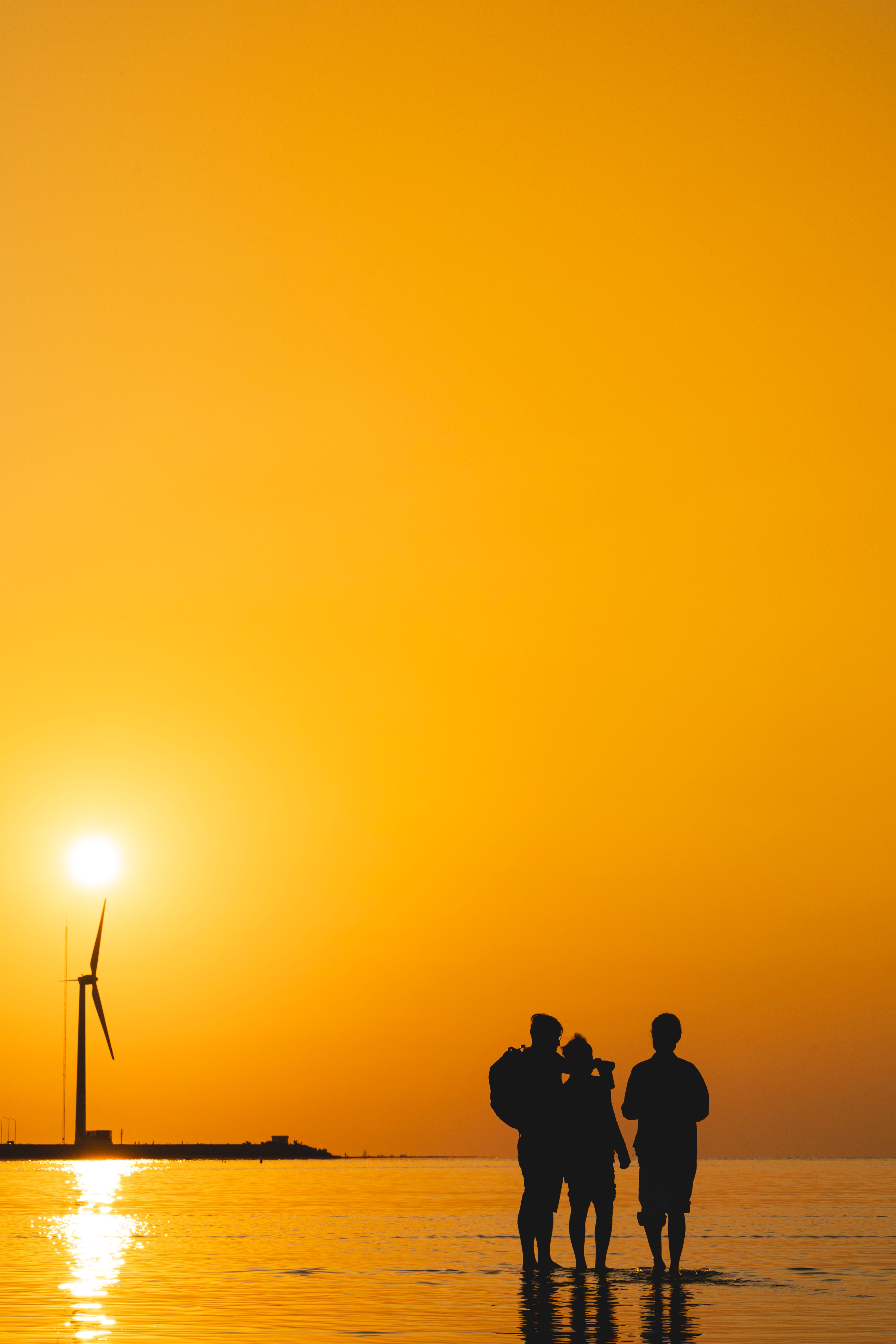 Silhouette of People at Sunset by Wind Turbine · Free Stock Photo
