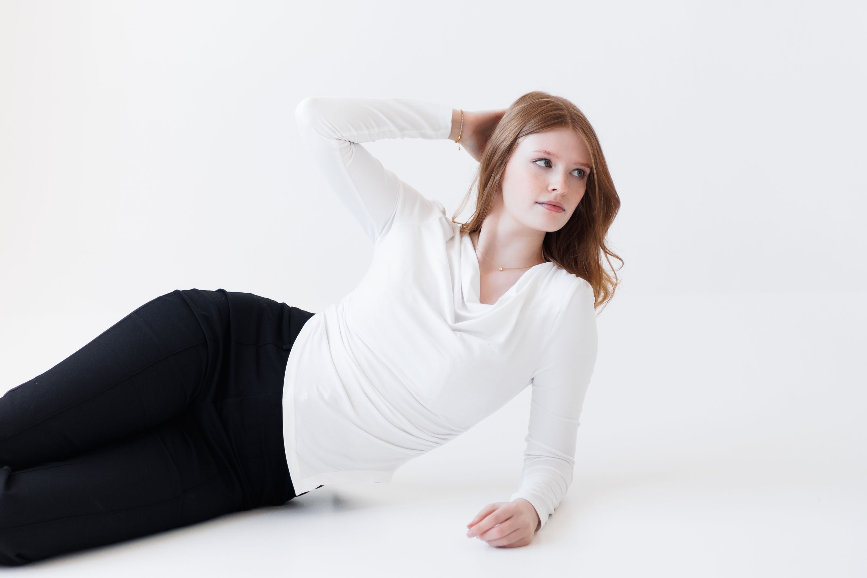 Woman in white wrap top with black trousers