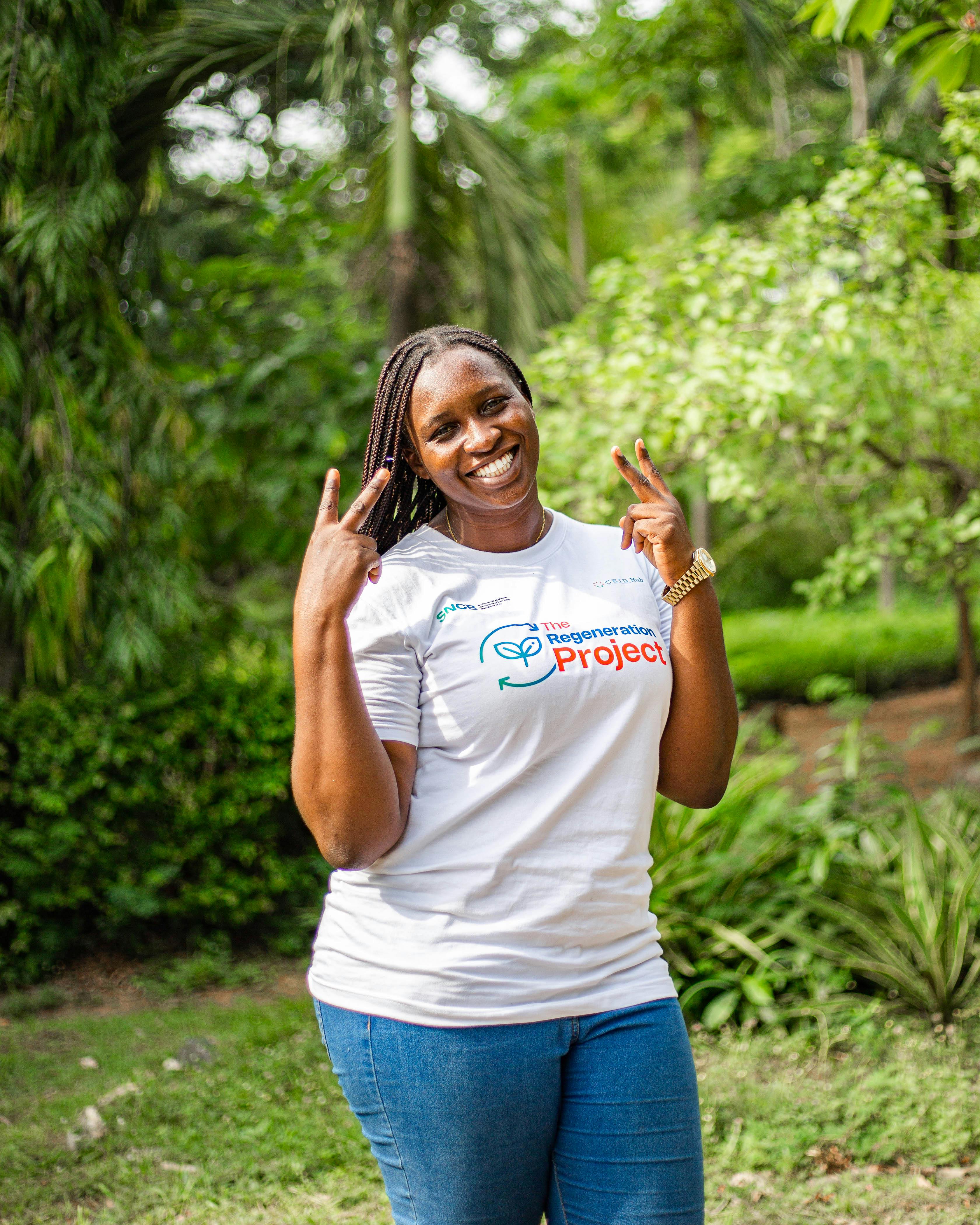 happy woman outdoors in nature peace sign