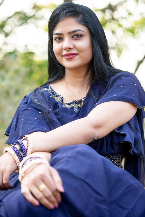 Free Portrait of a woman in a blue traditional dress outdoors, exuding elegance and confidence. Stock Photo