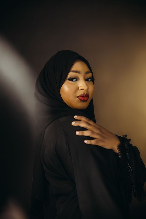 Free Striking portrait of an elegantly dressed woman in a black hijab with a serene expression. Stock Photo