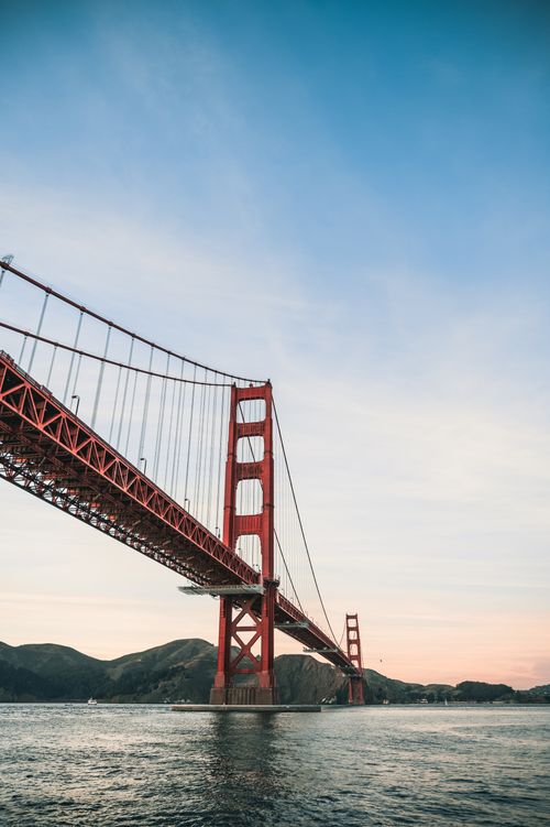 Free A stunning view of the Golden Gate Bridge stretching over the water under a clear sky in San Francisco. Stock Photo