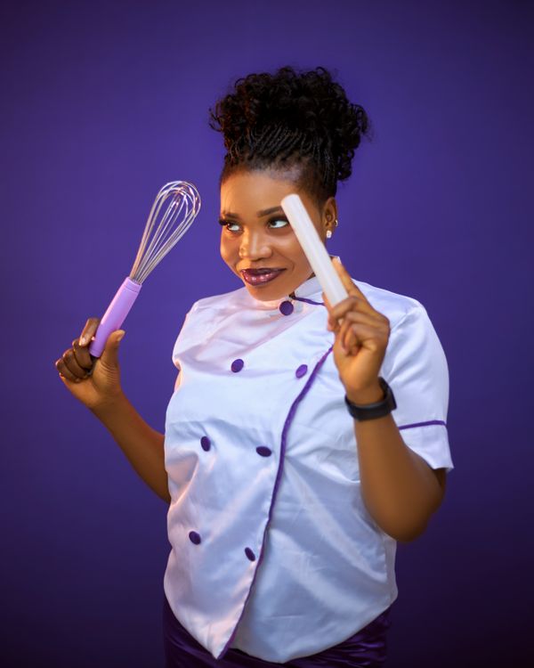 Smiling Chef Holding Whisk and Spatula on Purple · Free Stock Photo