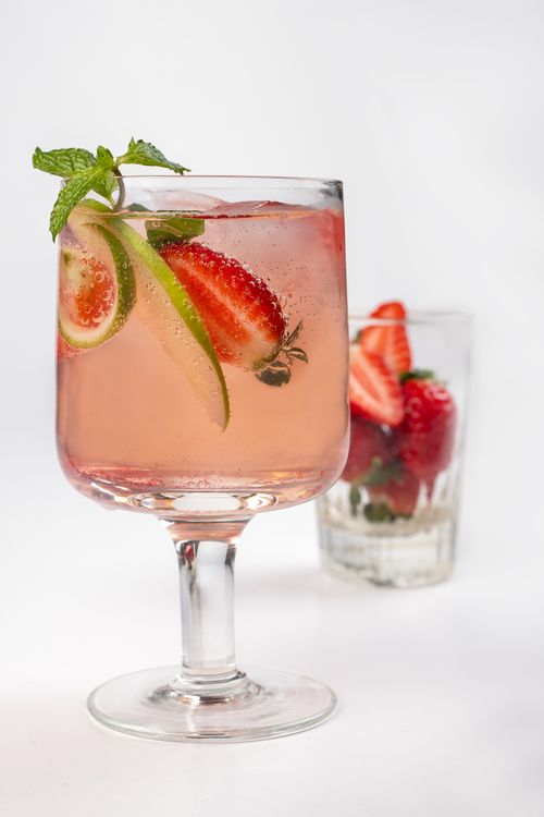 Free A refreshing strawberry and lime cocktail garnished with mint, perfect for summer days. Stock Photo