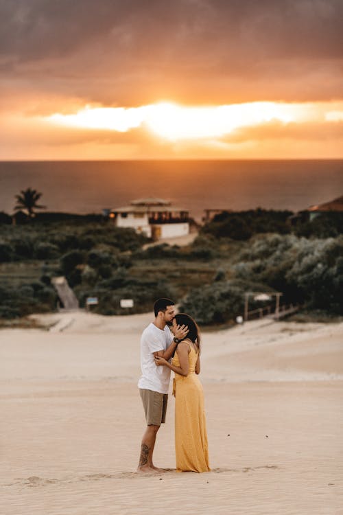 Free Man and Woman Kissing at a Beach Stock Photo