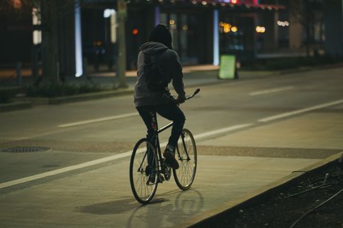 Free A cyclist rides through the dimly lit streets of Houston, Texas at night. Stock Photo
