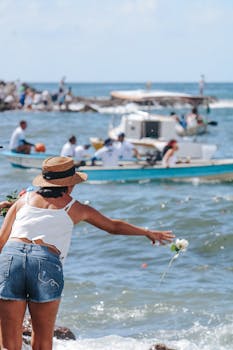 A woman participates in a traditional ceremony by the ocean in Salvador, Bahia, Brazil.