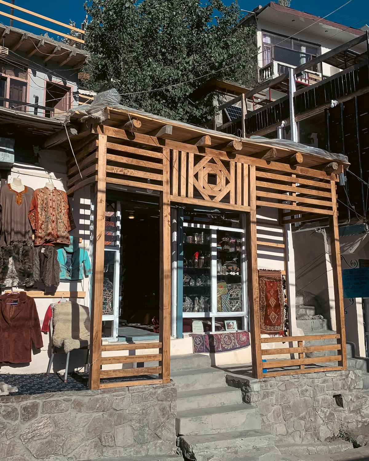 Rustic Storefront with Handcrafted Clothing Display · Free Stock Photo