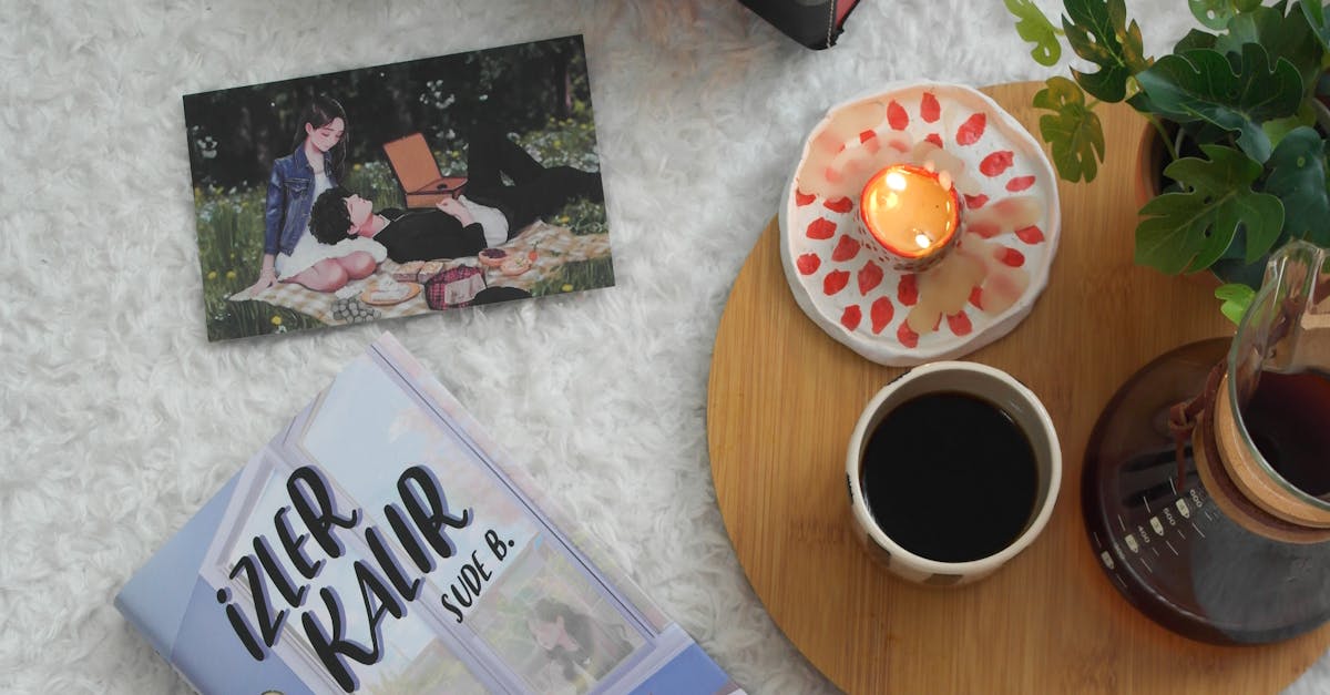 Flat lay of a cozy reading nook with a book, coffee, candle, and record player on a fluffy rug.