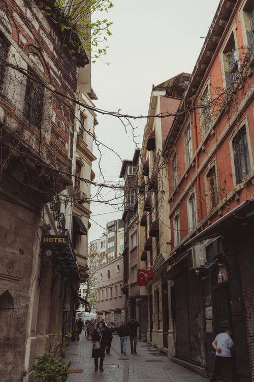 Free A picturesque European street lined with historic, colorful buildings and a sense of daily life. Stock Photo
