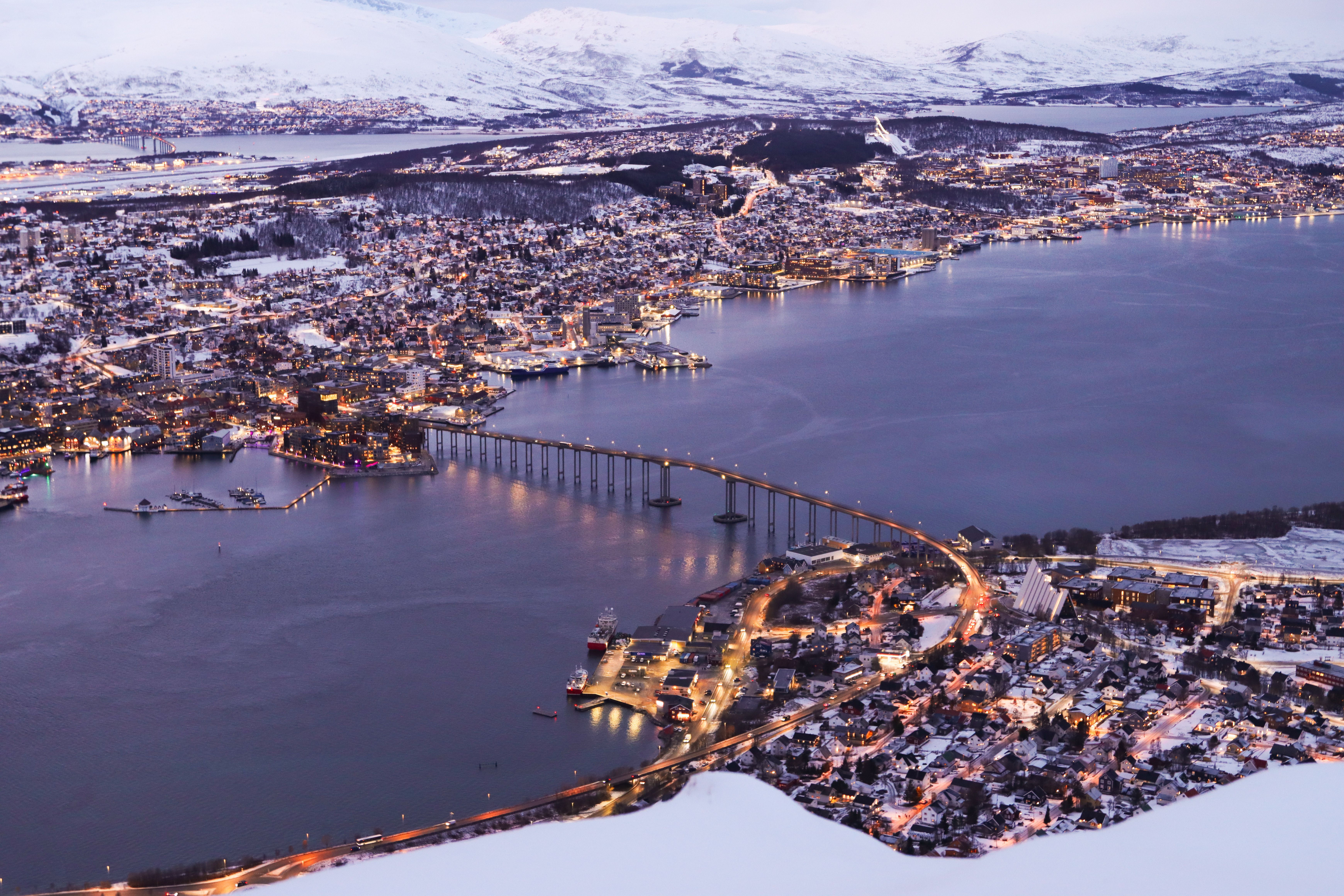 Aerial view of Tromso, Norway at twilight with mountains and fjord