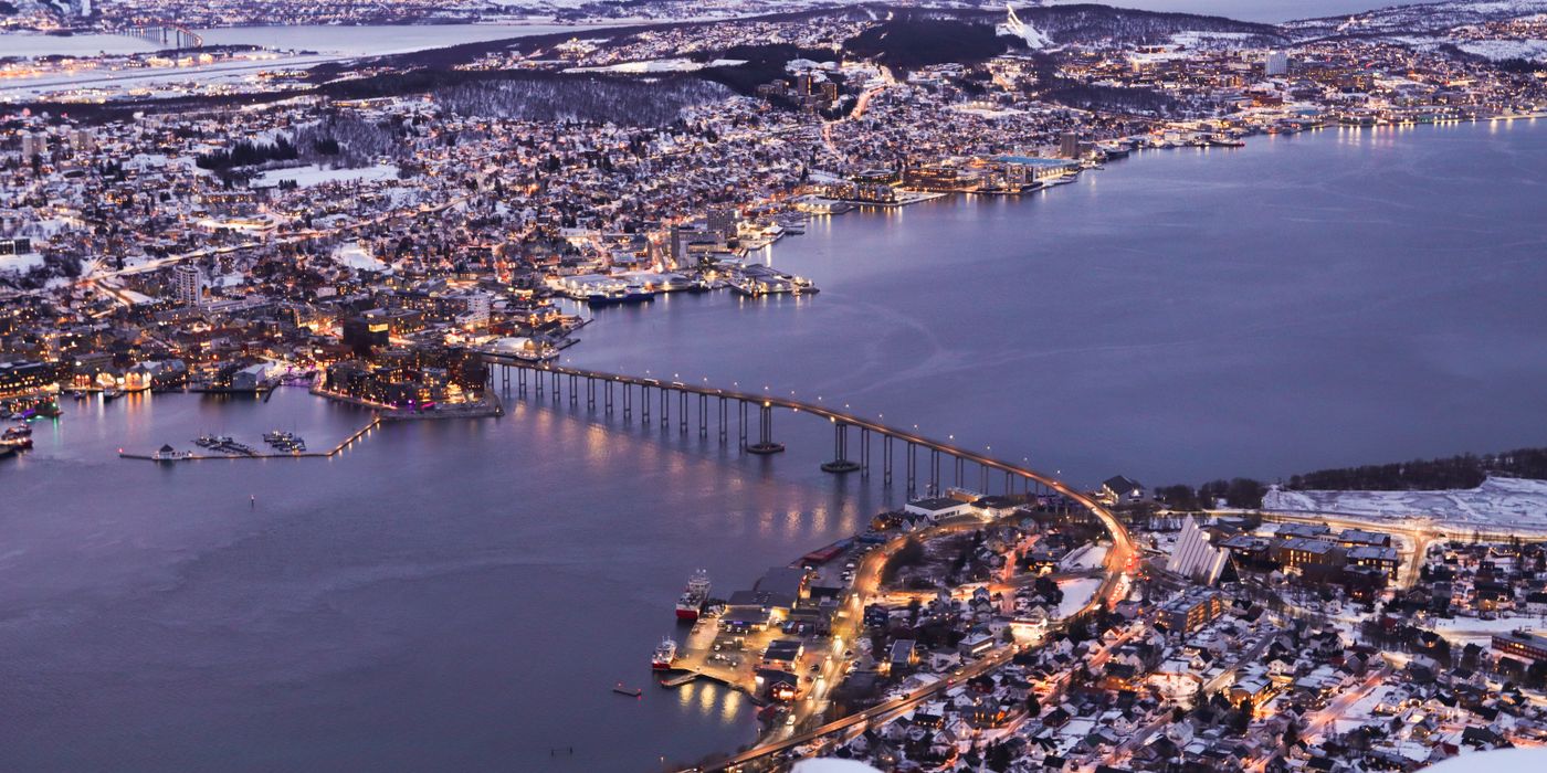 Aerial view of Tromso, Norway at twilight with mountains and fjord