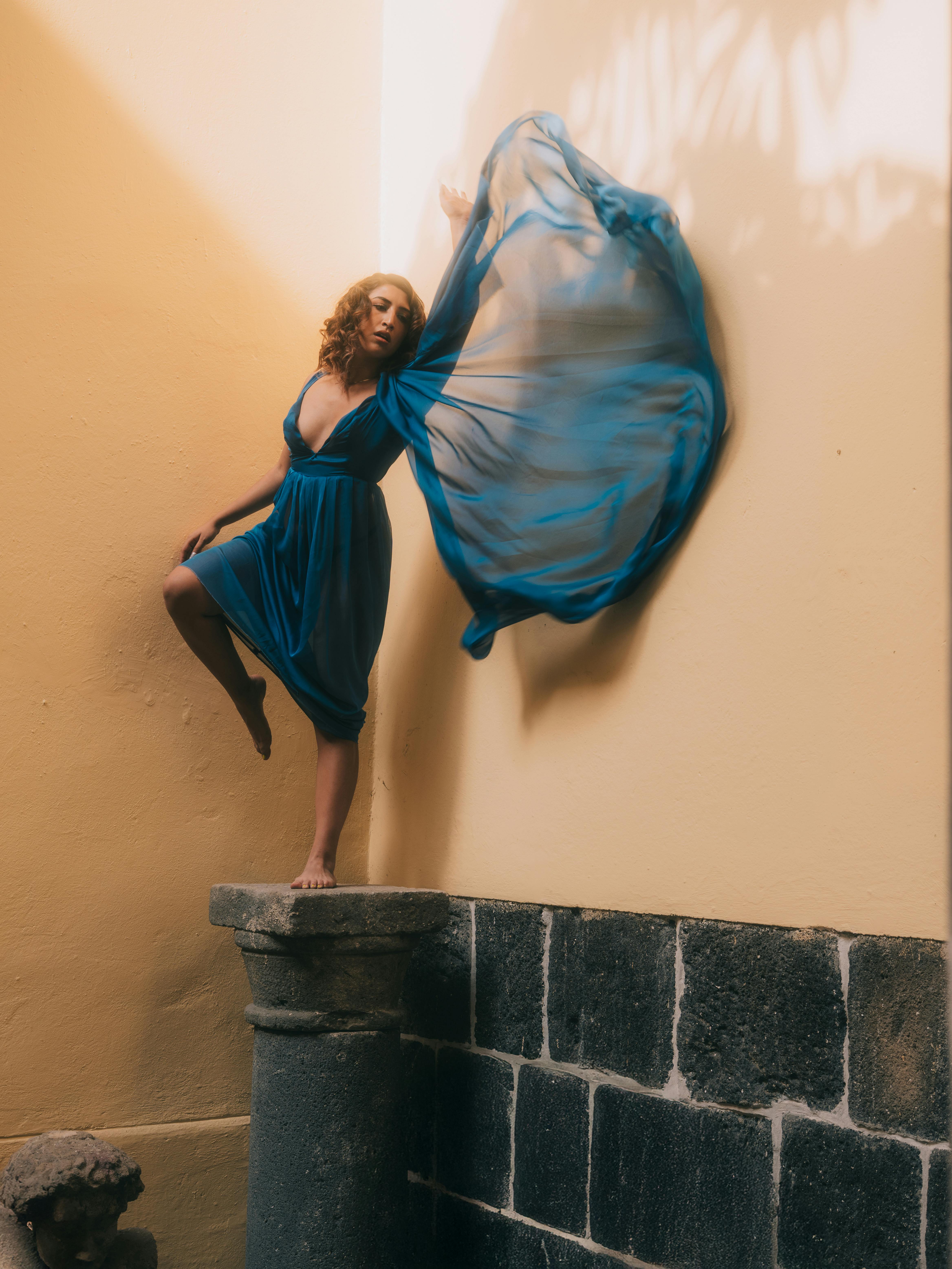 Free Captivating fashion model poses in blue dress within a historic Mexican setting. Stock Photo