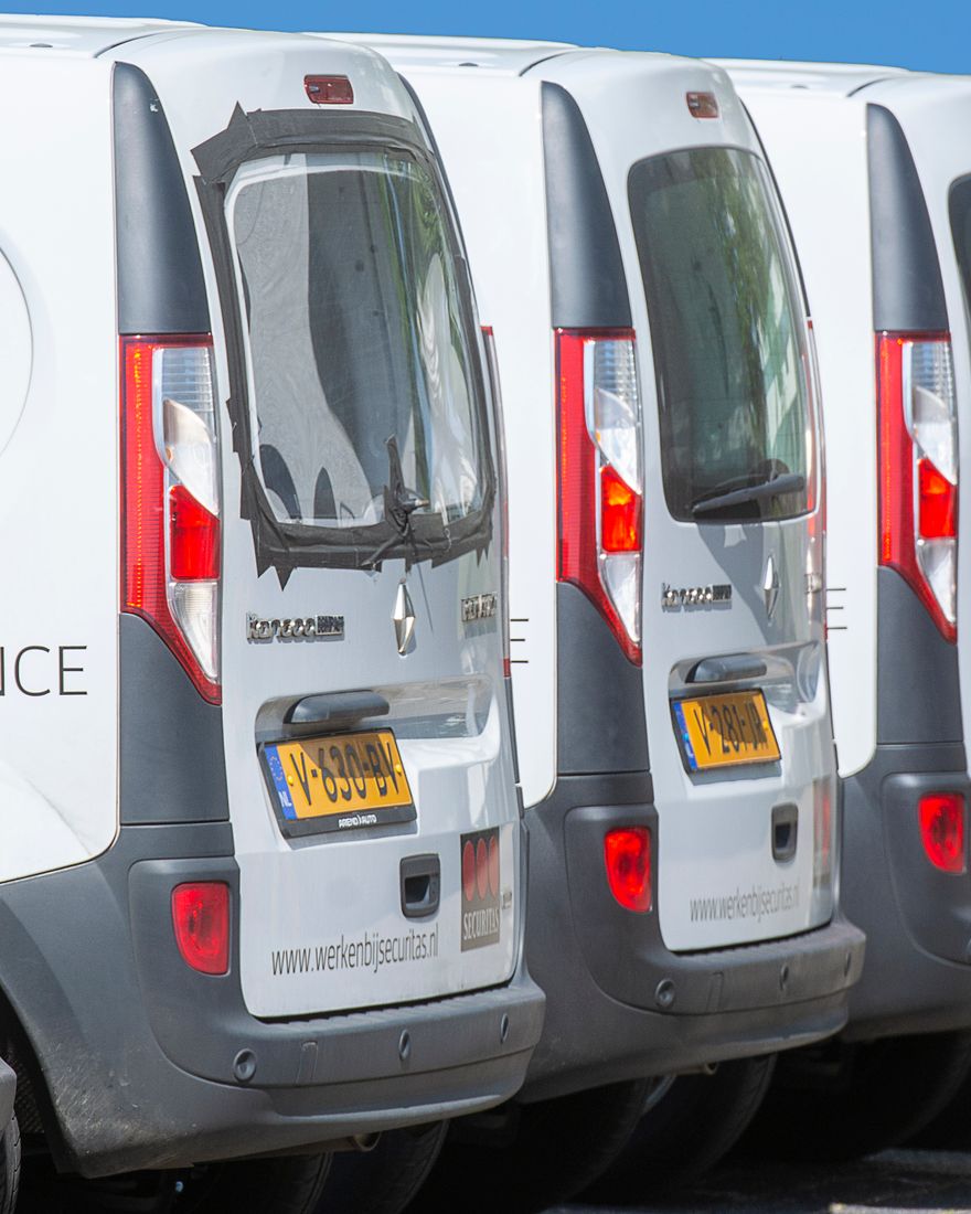 A fleet of white work vans parked in a row