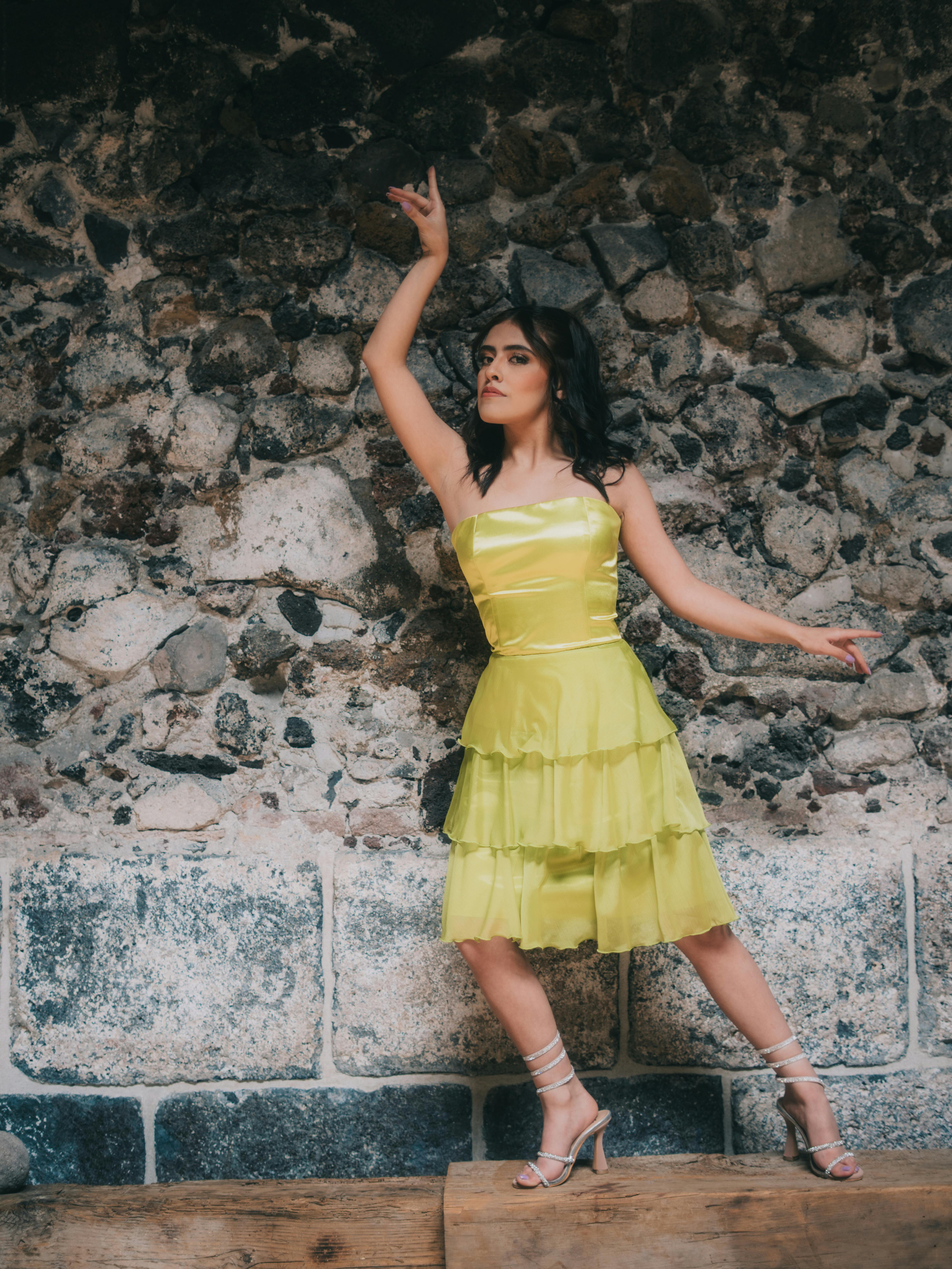 Free Chic fashion model poses in designer outfit against rustic Mexico City backdrop. Stock Photo