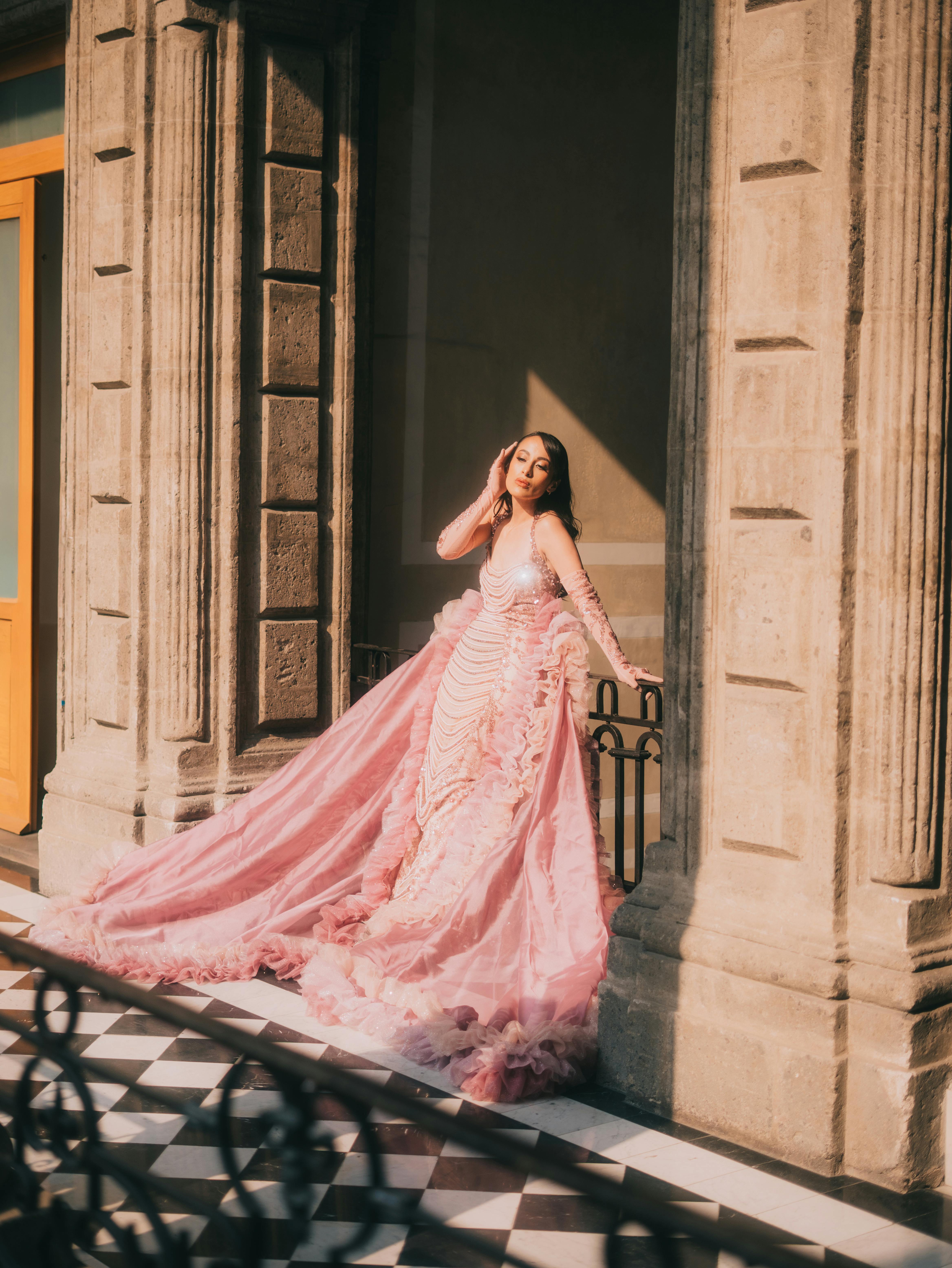 Free Fashion model posing in a luxurious pink gown at a historic location in Mexico City. Stock Photo