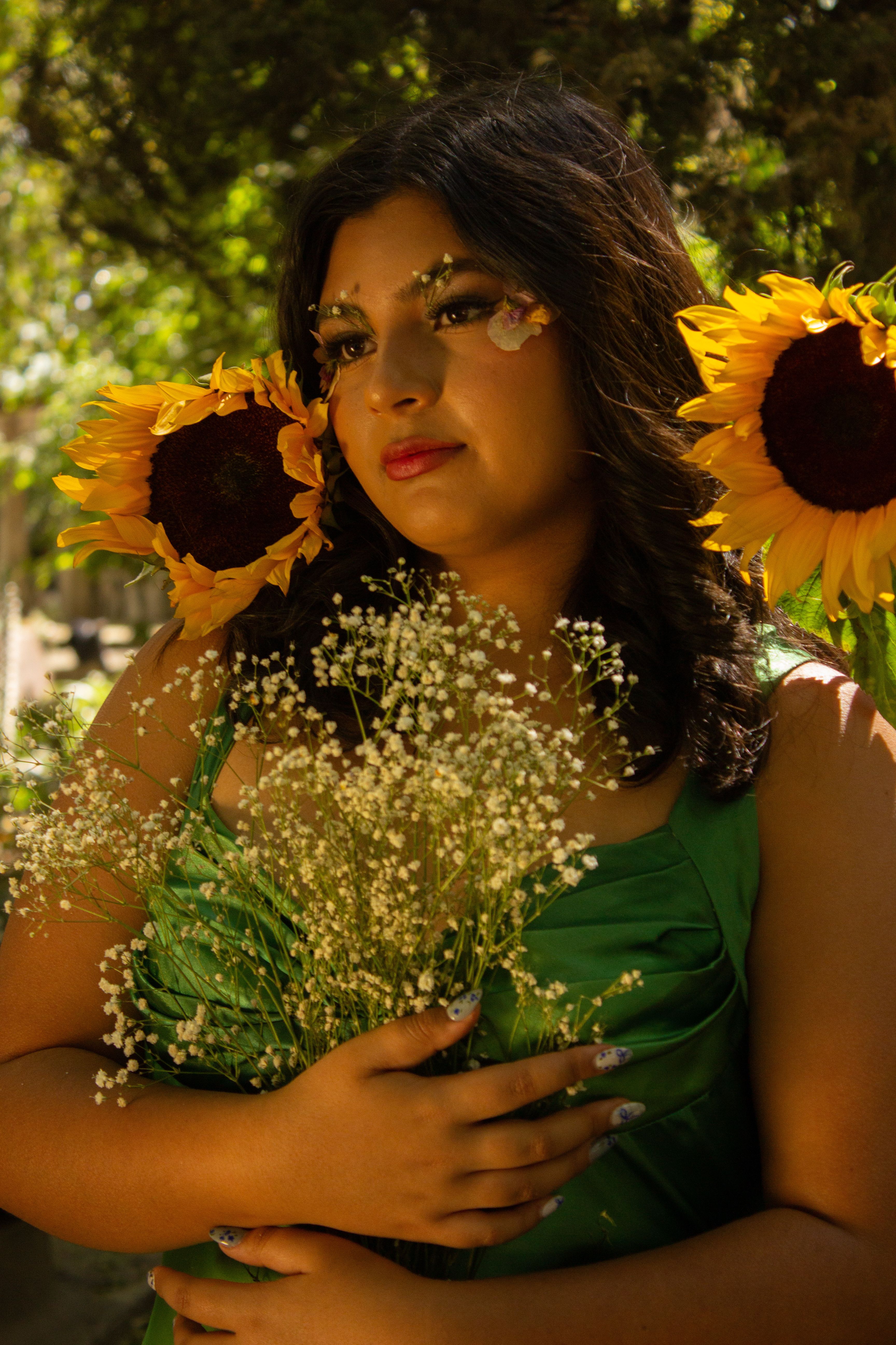 Woman Posing with Sunflowers in a Green Dress · Free Stock Photo