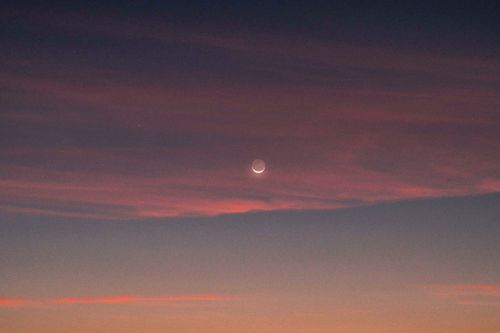 Free Crescent moon in a colorful twilight sky over Cefalù, Sicily, capturing the serene beauty of dusk. Stock Photo
