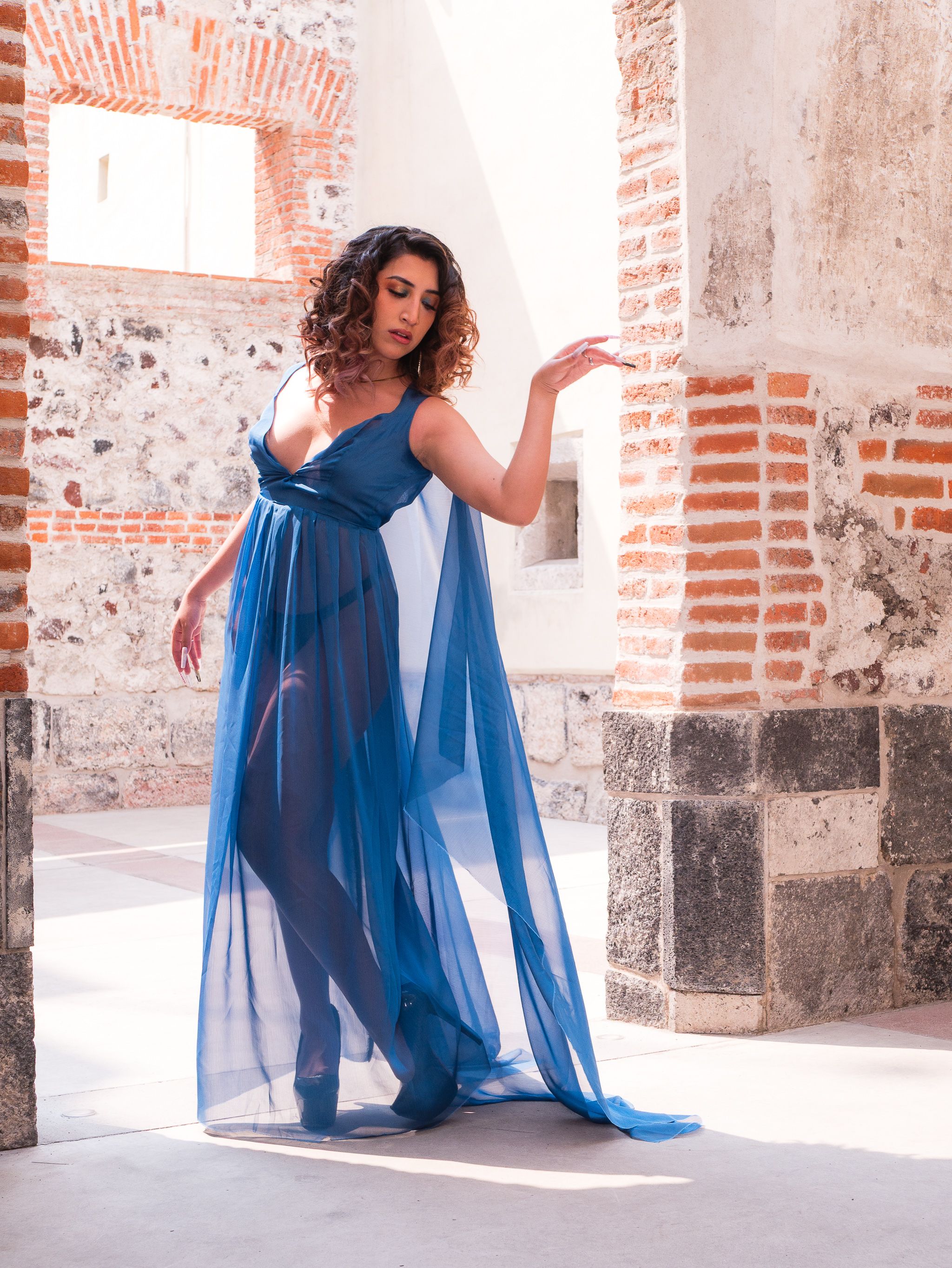 Elegant Woman in Blue Dress at Historic Site · Free Stock Photo