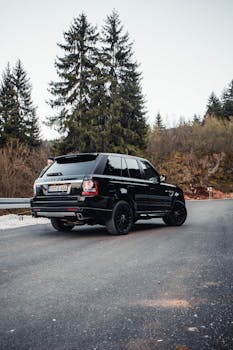 Luxury SUV captured on a winding mountain road near Sarajevo, showcasing exploration and freedom.