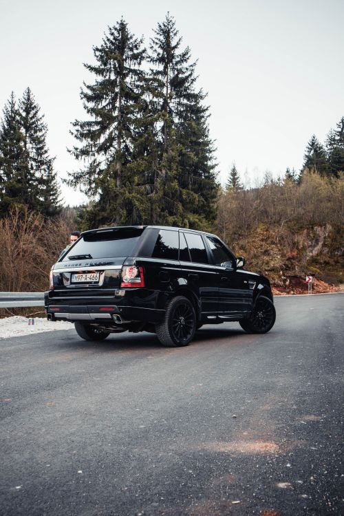 Free Luxury SUV captured on a winding mountain road near Sarajevo, showcasing exploration and freedom. Stock Photo