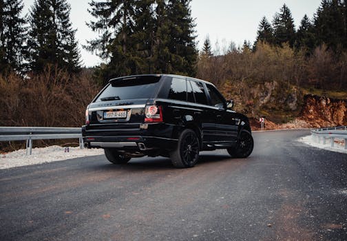 Explore the winding mountain roads near Sarajevo with this elegant Land Rover SUV, set against a vibrant autumn backdrop.