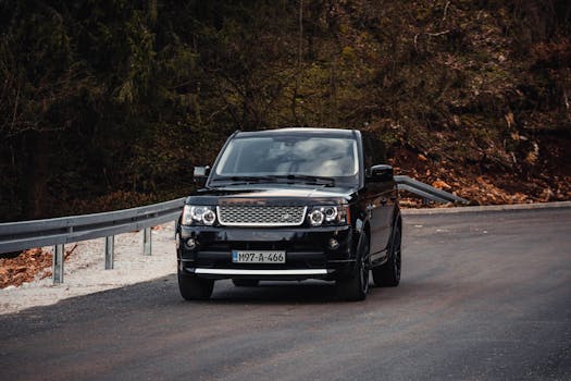 Stylish SUV driving on a winding mountain road near Sarajevo, offering a blend of adventure and elegance.