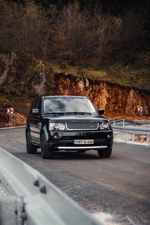 Free Explore the elegant Range Rover on a winding countryside road in Sarajevo, Bosnia. Stock Photo