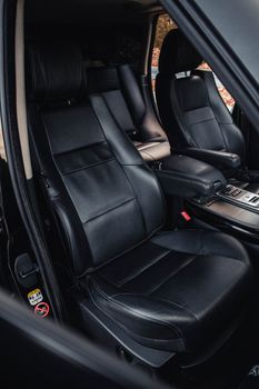 High-quality black leather seats inside a luxury car, showcasing elegance and comfort.