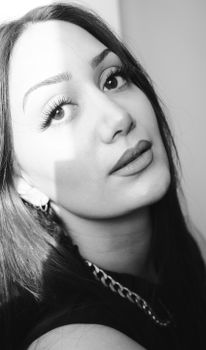 Elegant black and white portrait highlighting youthful beauty and expressive gaze.