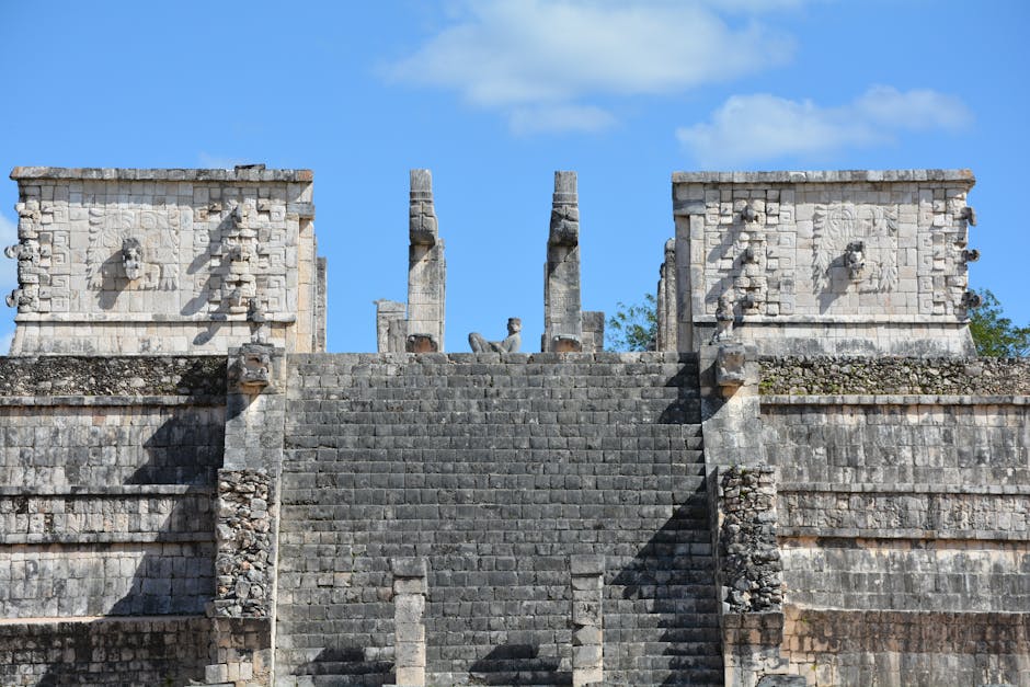 ancient mayan civilization historical tour packages for agencies - Explore the ancient Mayan temple at Chichen Itza showcasing detailed stone carvings under a clear blue sky.