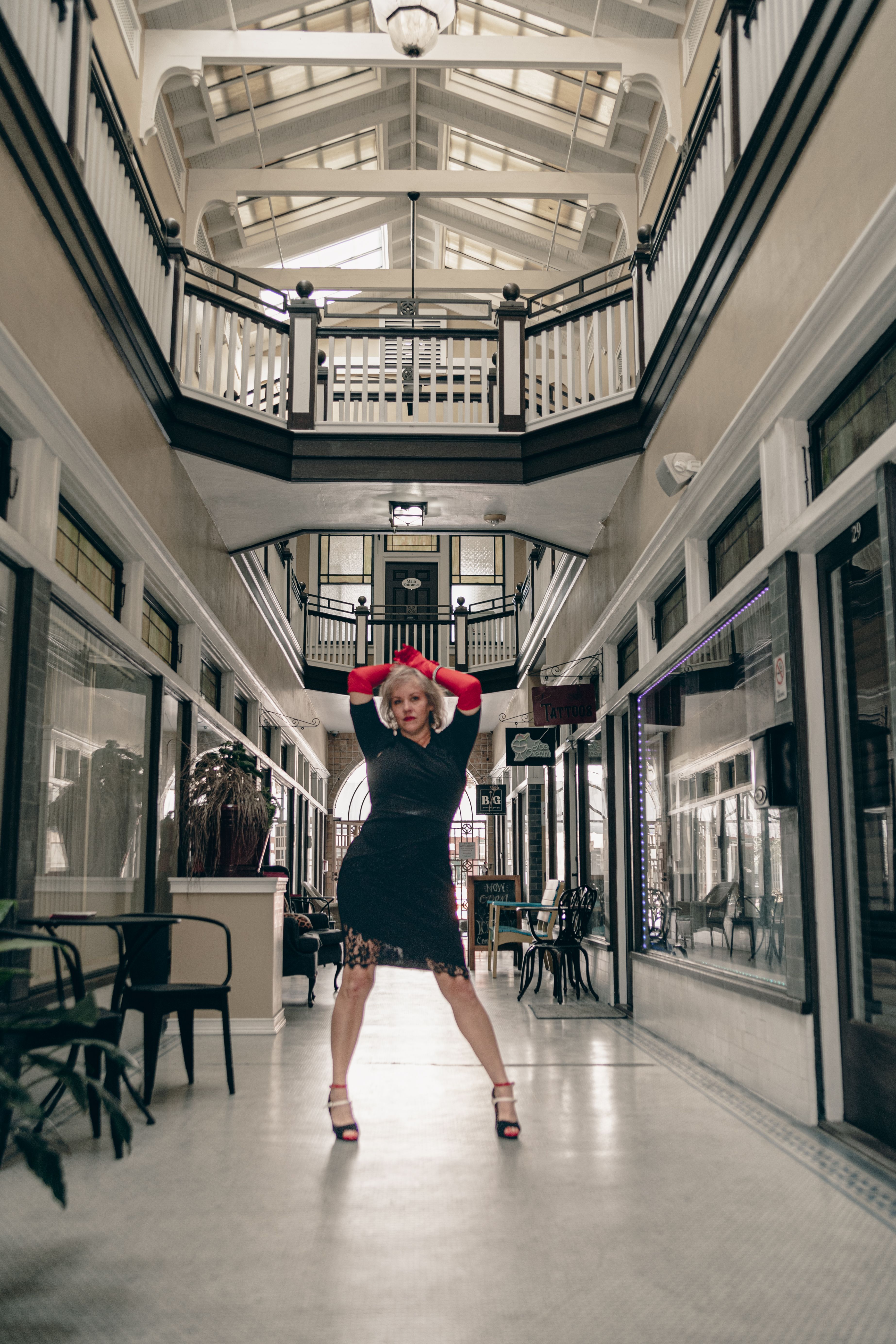 Stylish Woman Posing in Indoor Atrium · Free Stock Photo