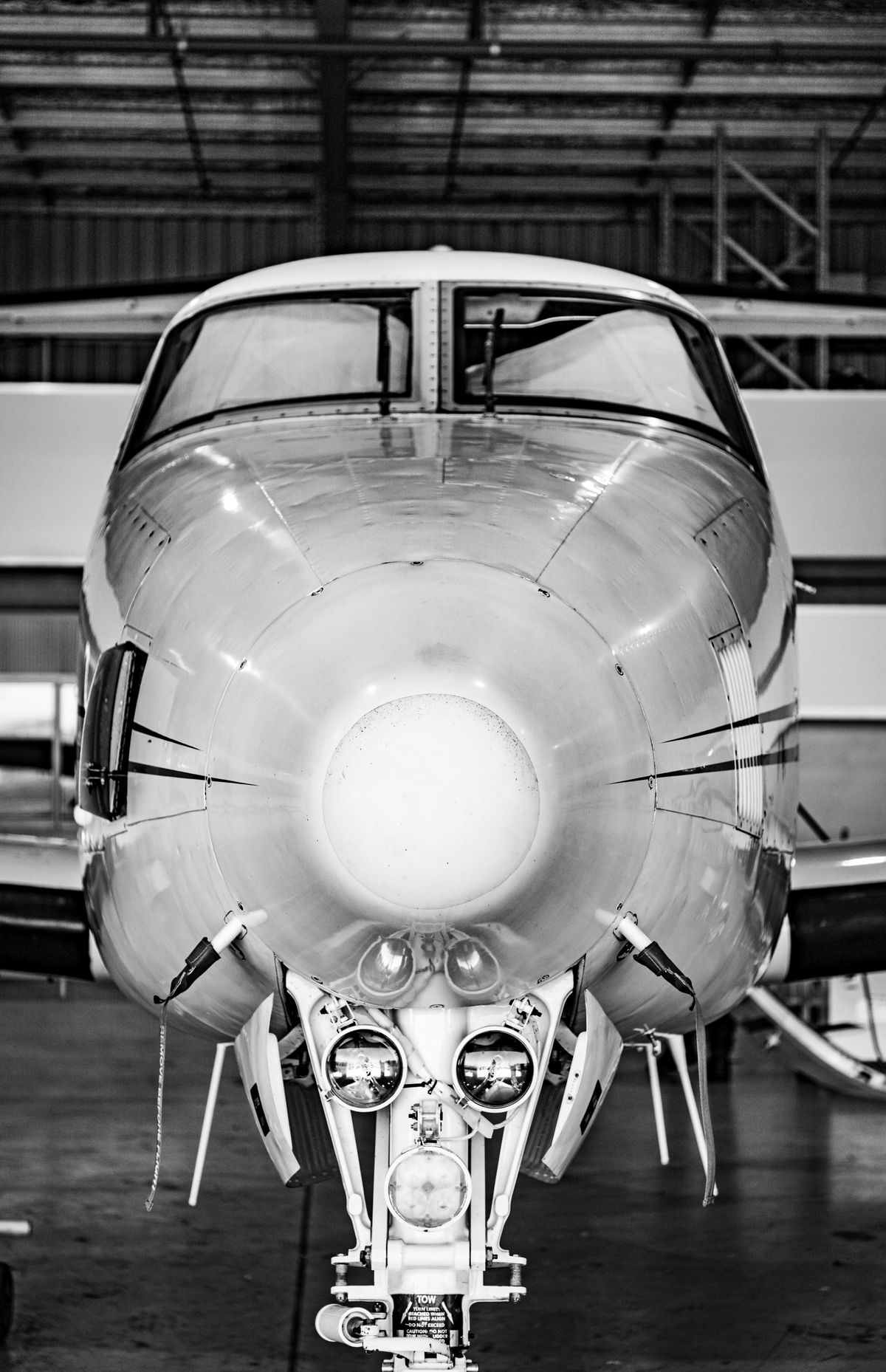 Private jet nose, front view in the hangar