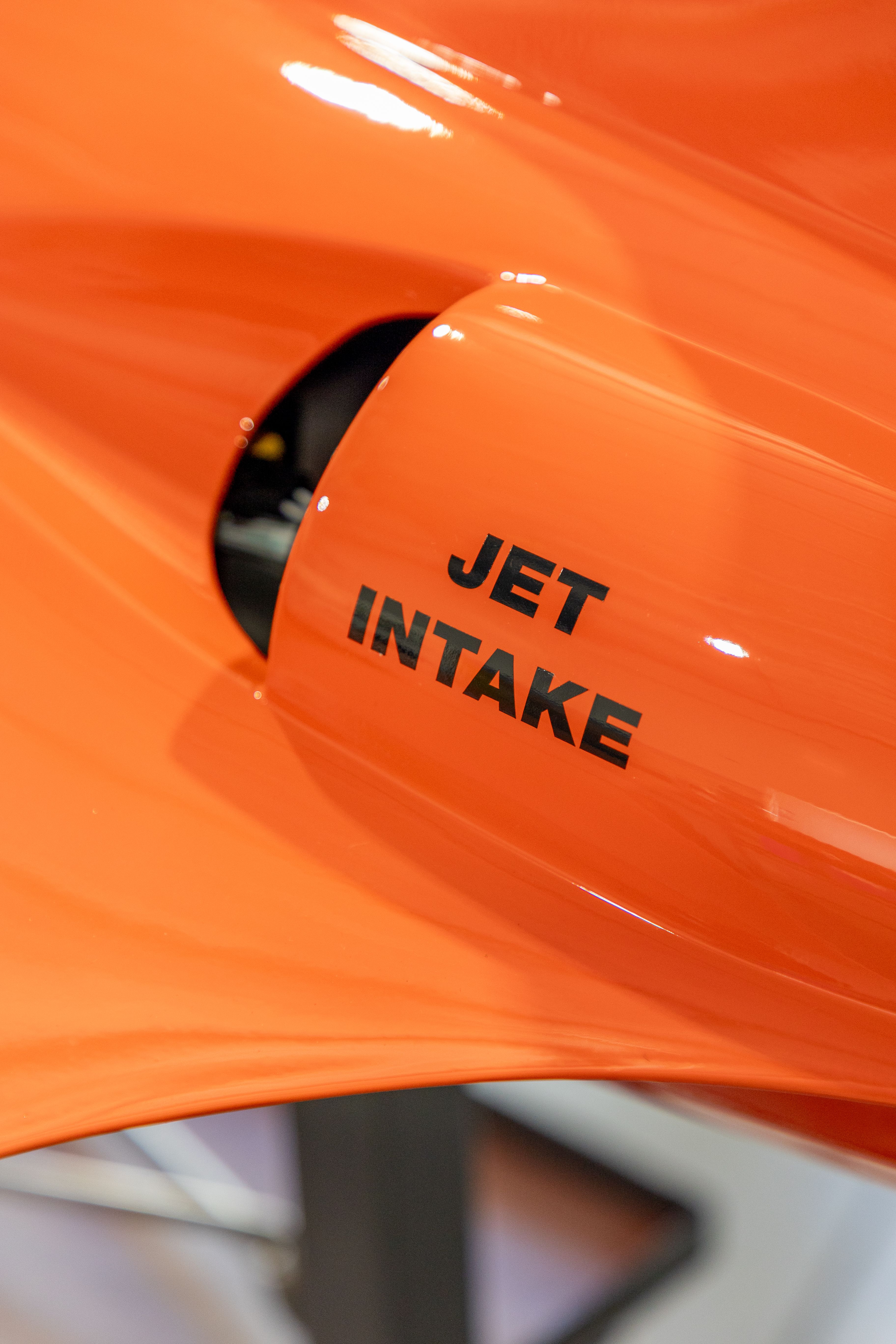 Close-Up of Orange Jet Intake with Text · Free Stock Photo