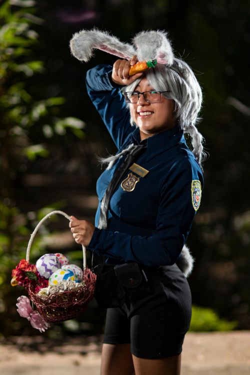 Free A cosplay enthusiast dressed as a bunny officer from a popular animation series, holding Easter basket outdoors. Stock Photo