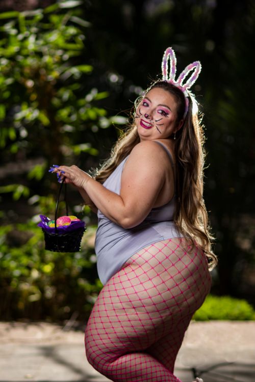 Free Woman dressed in bunny costume holding Easter basket outdoors during daytime. Stock Photo
