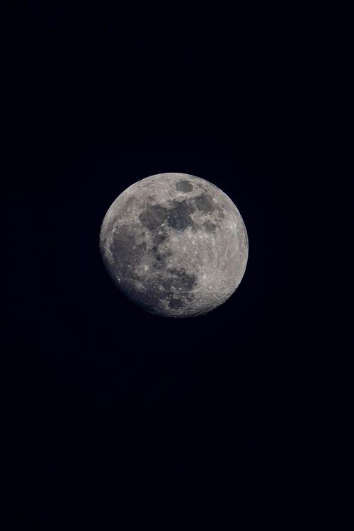 Free Close-up of the full moon against a deep black night sky, showcasing craters and details. Stock Photo
