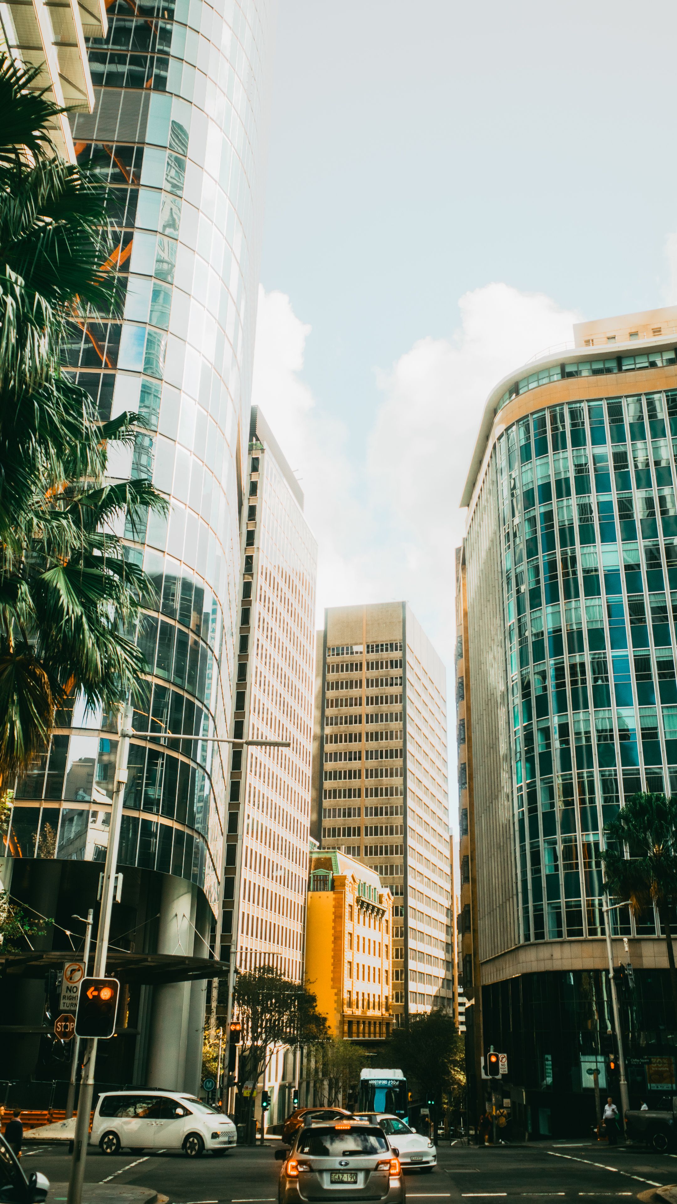 Vibrant street in Sydney showcasing towering skyscrapers and urban life.