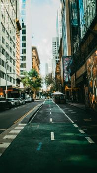 Dynamic street scene at central Sydney with tall buildings and vibrant urban life.