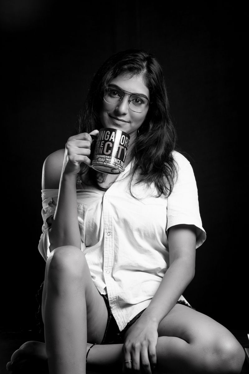 Elegant black and white portrait of a woman holding a coffee mug