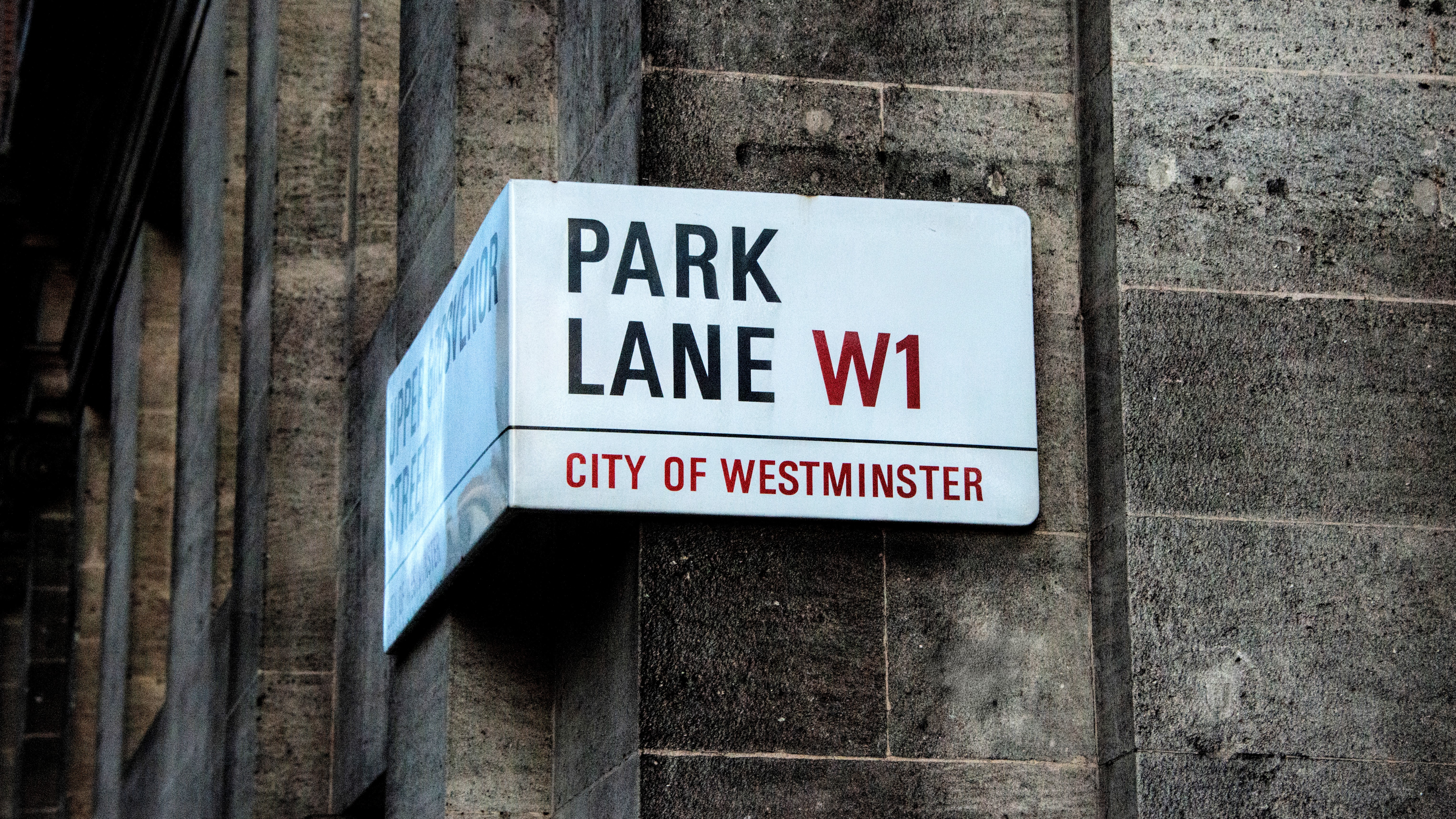 Close-up of Park Lane street sign in Westminster, London, showcasing urban signage.