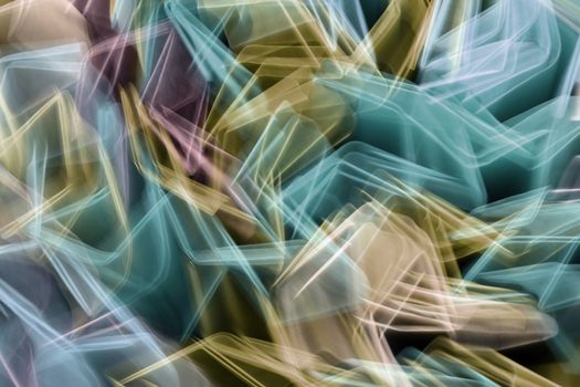 Colorful long exposure abstract of blurred light trails creating dynamic patterns.
