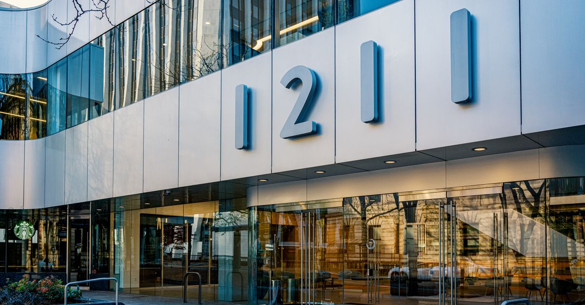 Contemporary architecture of office building facade with glass reflections in Portland, Oregon.